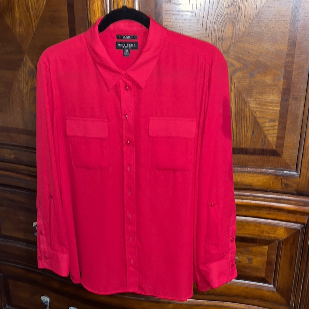 Red button up blouse.